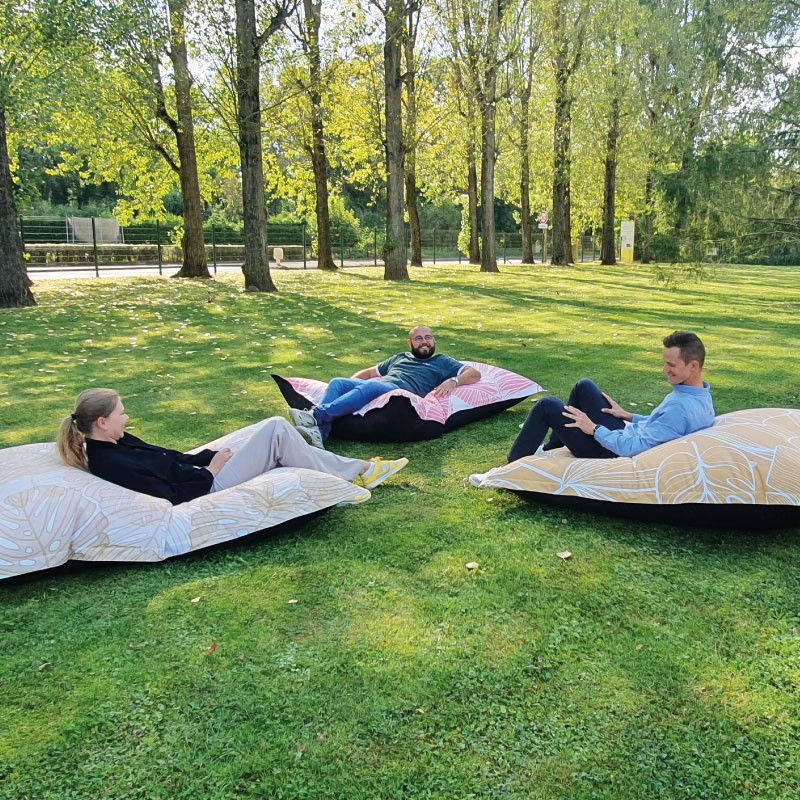 Coussins géants imprimés installés dans un jardin